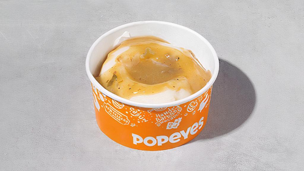 Mashed Potatoes With Gravy · Mashed potatoes covered with our flavorful cajun gravy.