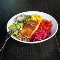 Salmon Bowl · Salmon, quinoa, arugula, avocado, mango, cherry tomato, pickled cabbage, and green tahini dr...