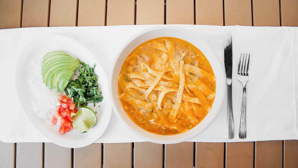 Chicken Tortilla Soup - Bowl · A savory chicken soup loaded with rice, onions, tomatoes and cilantro. Topped with freshly chopped avocados and crunchy tortilla strips.