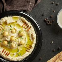 Hummus · Chick peas blended with tahini, garlic and lemon juice, topped with paprika, cumin, and extr...