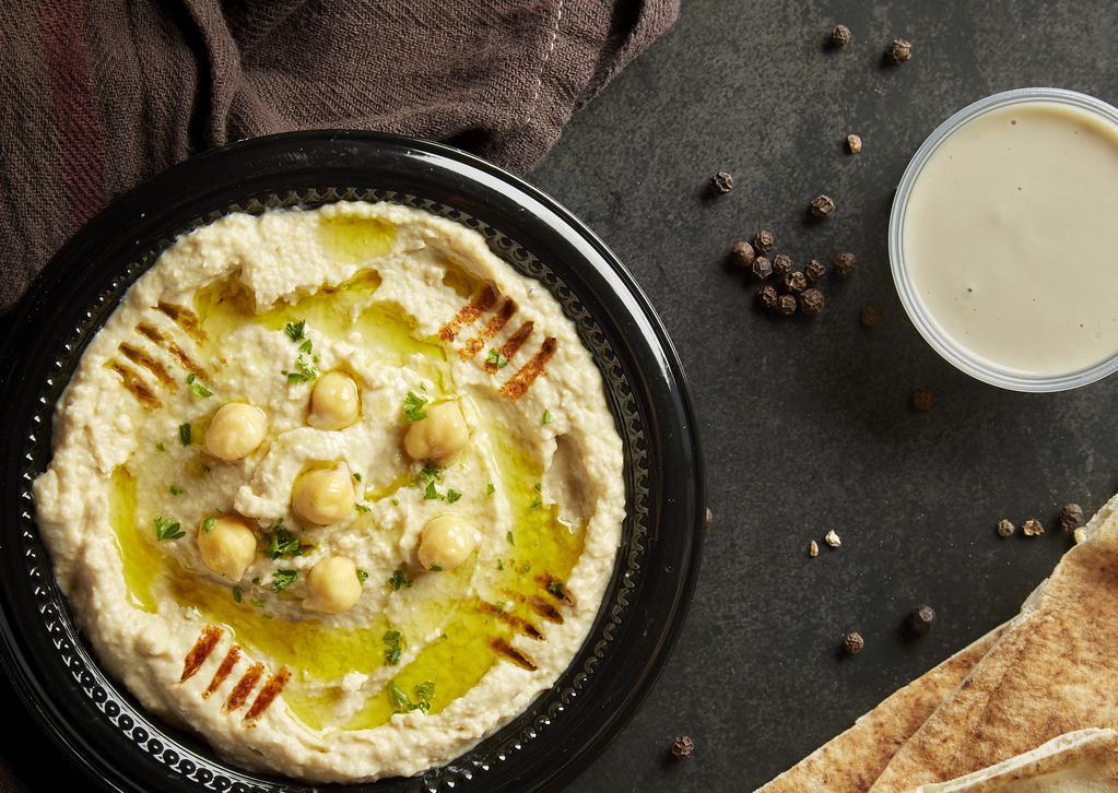 Hummus · Chick peas blended with tahini, garlic and lemon juice, topped with paprika, cumin, and extra virgin olive oil. Served with pita bread.