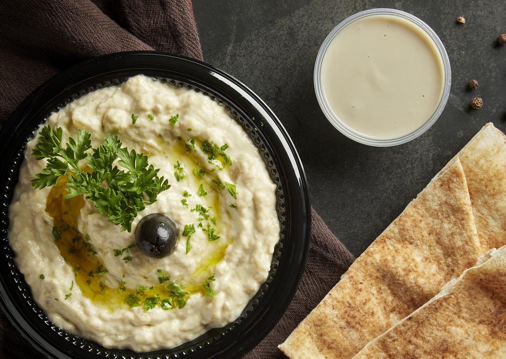 Baba Ghanouj · Roasted eggplant blended with tahini, garlic and lemon juice, topped with paprika and extra virgin olive oil. Served with pita bread.