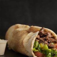 Beef Shawarma Wrap · Selected layers of beef, marinated with herbs and spices. Roasted and served in pita bread w...