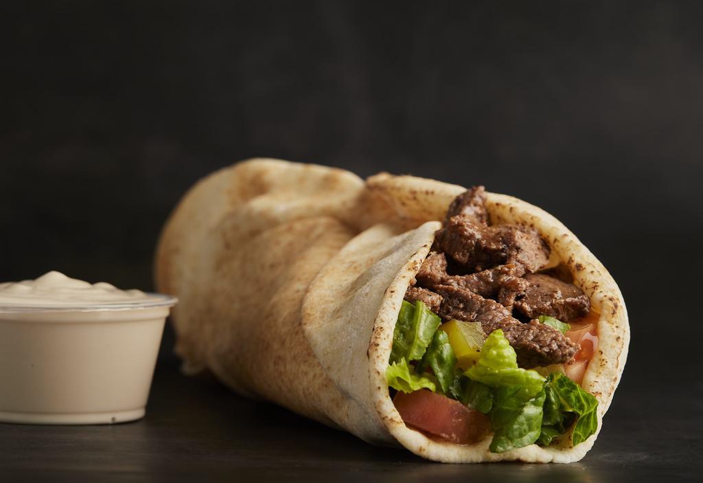 Shawarma Mix Meat Chicken Wrap · Skinless, boneless chicken breast, selected layers of beef, marinated with herbs and spices. Roasted and served in pita bread with lettuce, tomatoes, pickles, and tahini sauce.