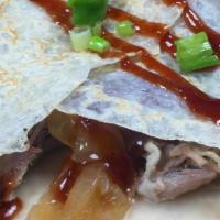Shredded Pork Bbq Crepe · The Shredded BBQ pork crêpe is complimented with caramelized onions, roasted peppers, BBQ sa...