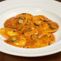Lobster Ravioli · Maine lobster and ricotta stuffed raviolis served with a creamy lobster sauce & sautéed shri...