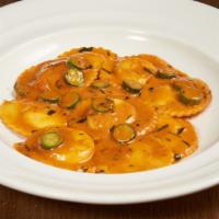 Lobster Ravioli · Maine lobster and ricotta stuffed raviolis served with a creamy lobster sauce & sautéed shri...