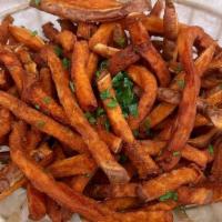 Basket Of Sweet Potato Fries · A basket of crispy, hand-cut sweet potato fries.