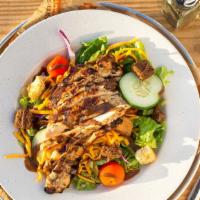 Grilled Chicken Salad · Crisp lettuce served with tomatoes, cucumber, cheese and sliced, marinated boneless chicken ...