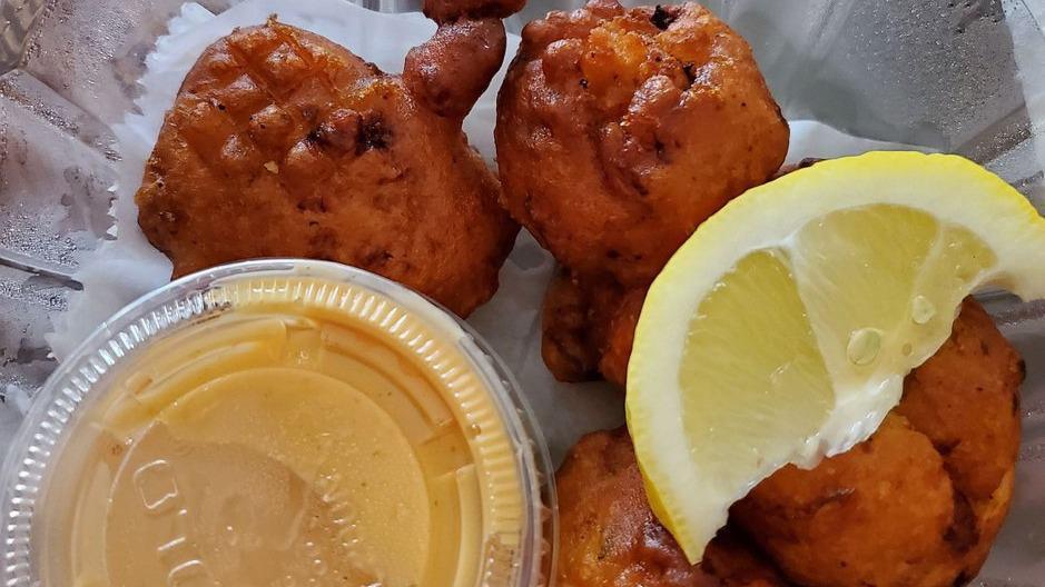 Caribbean Style Conch Fritters · This Bahamian treasure is worth its weight in gold! Tender, juicy conch folded into a
seasoned batter of diced onions and peppers. Made fresh to order, these hors
d'oeuvre will pair well with any of our delicious entrees.
