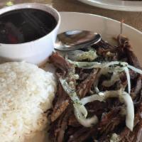 Vaca Frita · Crispy beef, white rice, black beans, salad and French fries.
