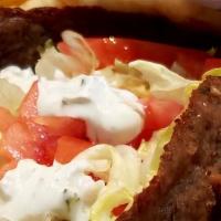 Lamb Gyro · Greek style seasoned lamb cooked on a spit and wrapped in a pita with lettuce, tomato, and a...