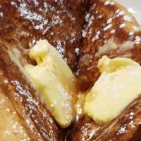 French Toast · Made with fresh baked Challah Bread served with butter and syrup