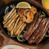 Fajitas (Trio) · A trio of flavor on a sizzling skillet with juicy grilled shrimp, Angus skirt steak and seas...