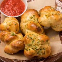 Astra-Knots · 6 garlic knots served with Herb Tomato Dipping Sauce.
