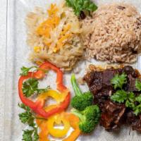 Oxtail · Served with your choice of Rice and Peas or White Rice, steamed Cabbage (Can be replaced wit...