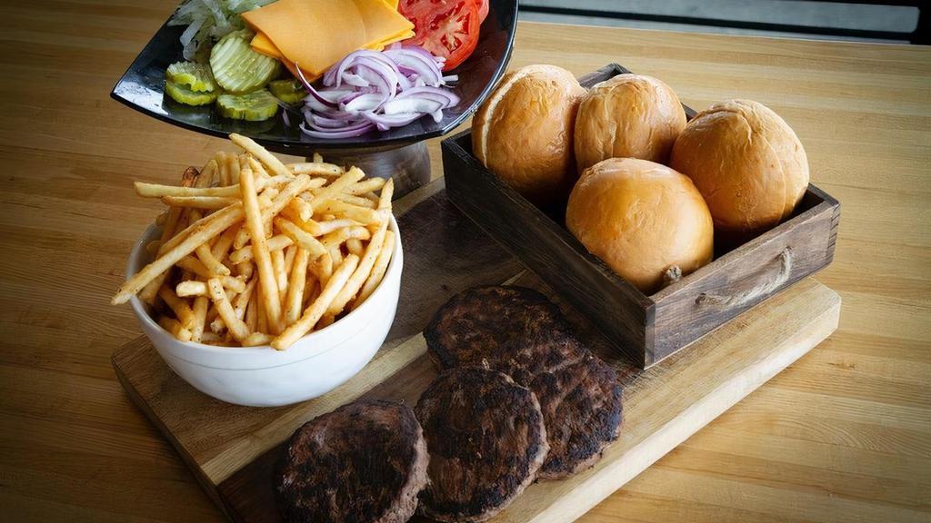 Burger Box · Feeds 4. Four homemade buns, 4 medium-well beef patties with Cheddar cheese, toppings: lettuce, tomato, pickles, tomato, red onions, mayo and mustard, family order of fries, and 4 peanut butter cookies.