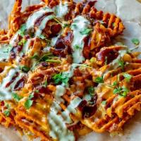 Loaded Sweets · Sweet Potato Waffle Fries fried to perfection topped with cheese, bacon, roasted jalapenos, ...