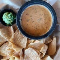 Chipotle Queso · Creamy, homemade queso blended with roasted chipotle peppers and pico de gallo.