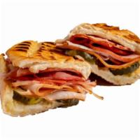Cuban Panini · Sliced turkey breast, melted Swiss, ham, pickles, and Dijon mustard on a Milano roll.