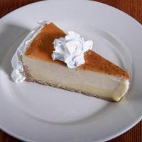 Crème Brule Cheesecake · Creme Brule flavored cheesecake served with caramel drizzle on top.