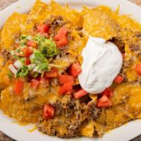Super Nachos · Chips, beans and cheddar cheese melted with your choice of chicken or ground beef. Topped wi...