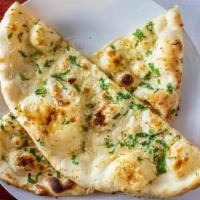 Garlic Naan · Fresh dough topped with chopped garlic baked in clay oven.