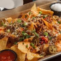 Korean Bbq Pork Nachos · Korean BBQ pork, queso, cheddar jack and cotija cheeses, fire roasted red peppers, onion and...