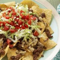 Nachos Supreme · Tortilla chips with cheese, beef, beans, lettuce, tomato, & sour cream