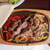 Fajita De Carne Asada · Grilled Steak, onion, and bell peppers. served with rice, beans, tortillas, and a gorro salad