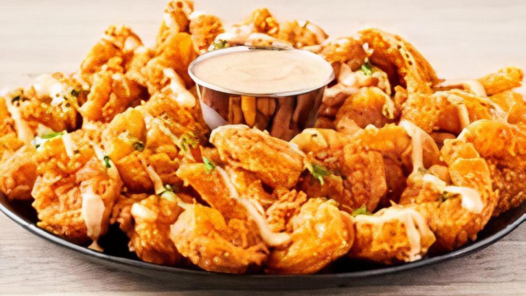 Bloomin' Fried Shrimp · Tender, bite-sized shrimp hand-breaded with our famous Bloomin’ Onion®spices and cooked until golden brown. Drizzled and served with our signature spicy bloom sauce.