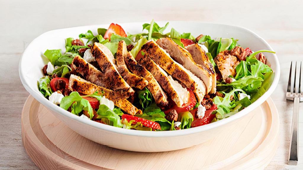 Strawberry Salad · Wild arugula and crisp romaine lettuce with fresh strawberries, cinnamon pecans and goat cheese crumbles, tossed in a raspberry vinaigrette.  Topped with your choice of grilled or crispy chicken.