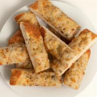 Vegan Double Cheesy Bread · Oven-baked bread sticks glazed in rich garlic butter and oregano and covered in an EXTRA thi...