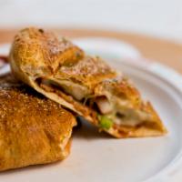 Sausage Calzone · Spicy Italian sausage, tender green peppers and onions, our signature gourmet cheese mix and...