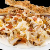 Fettuccine Alfredo · Grilled chicken strips, bacon, Parmesan and our signature gourmet cheese blend served over a...