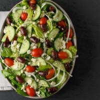 Greek Salad · Crisp romaine lettuce, ripe tomatoes, Feta cheese, kalamata olives, fresh onions, crunchy gr...