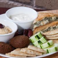 Appetizer Platter · Appetizer sampler consisting of spinach pie, falafel, pita bread, cucumbers, olives, hummus ...