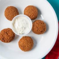 Falafel · Vegetarian. Traditional deep-fried mixture of seasoned ground chicka peas and fava beans. Se...