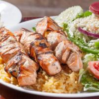 Salmon Skewers · Souvlaki. Three char-grilled salmon skewers over rice with a greek salad. 1277 cal.