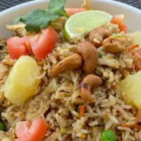 Pineapple Fried Rice · Contains peanuts. Jasmine rice stir fried with tomatoes, pineapple, onions, green onions, pe...