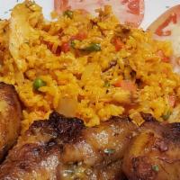 Arroz Con Pollo · Rice with sheered chicken, salad, and green or sweet plantain.