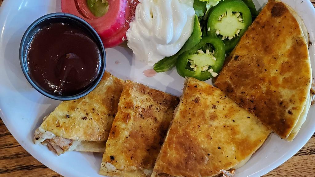 Smoked Pork Quesadilla · Pepper jack cheese, sweet heat BBQ, pickled red onion, fresh jalapeños, romaine lettuce & sour cream (850 CAL.).