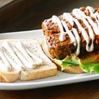 Buffalo Tempeh Sandwich · Sprouted tempeh baked in marinade and buffalo sauce, lettuce, tomato, garlic aioli, on slice...