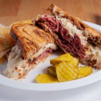 The King Reuben Sandwich · Freshly sliced corned beef, grilled sauerkraut and melted swiss cheese on toasted rye bread ...