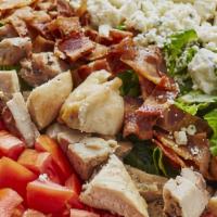 Traditional Cobb Salad · Romaine, grilled chicken, bacon, tomatoes, hardboiled egg,  Blue cheese crumbles, and toaste...