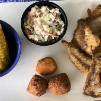 Catfish Platter (Cal 670) · Grilled, blackened or cajun, with our famous shrimp slaw, two hushpuppies, a corn fritter an...