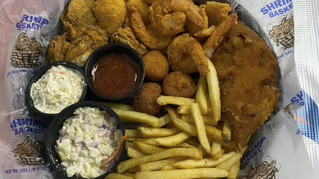 Seafood Basket (Cal 1100) · Shrimp, fish, oysters and stuffed crab served in a basket with fries, two hushpuppies, one corn fritter and our signature shrimp slaw.