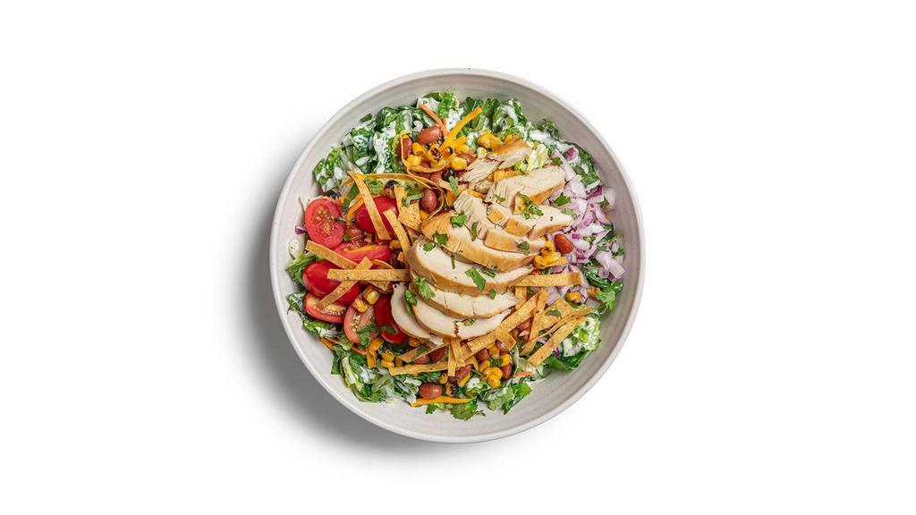 Southwest  · Chopped greens, rotisserie chicken, ranchero beans, sweet corn, grape tomatoes, red onions, cilantro, crunchy tortilla strips and shredded cheese.  Served with housemade Ranch dressing.