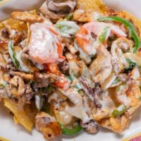 Fajita Nachos · Steak, chicken, and shrimp, grilled with onion, bell peppers, and tomatoes. Topped with nach...