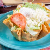 Taco Salad · Crispy flour tortilla with beef, beans, lettuce, tomatoes, cheese, sour cream, and guacamole.